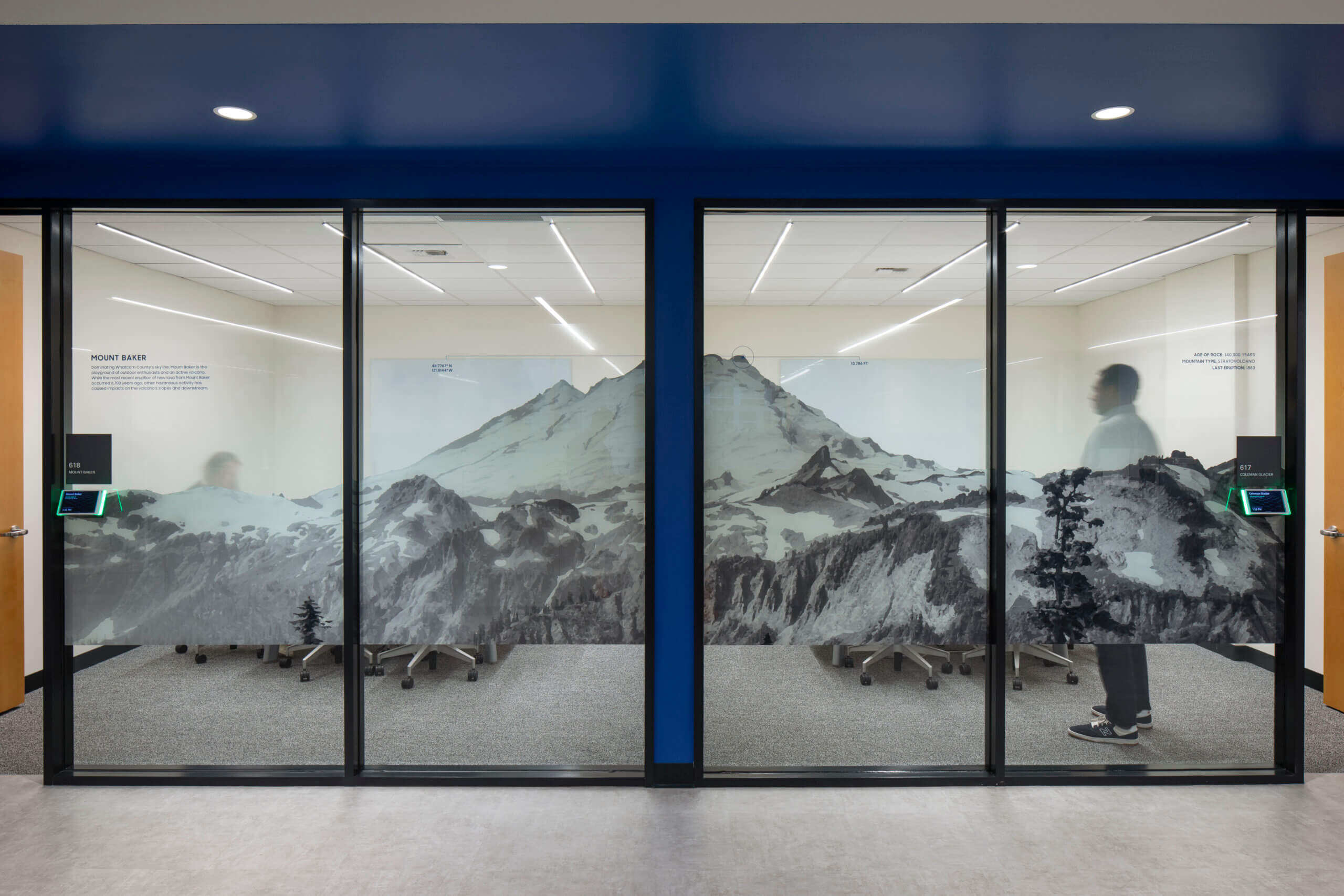 P O V from outside a conference room. The glass wall still offers privacy thanks to a graphic of the nearby Mount Rainier