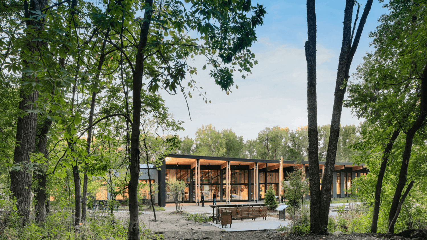 Westwood Hills Exterior Showcasing Mass timber beams and trees surrounding building