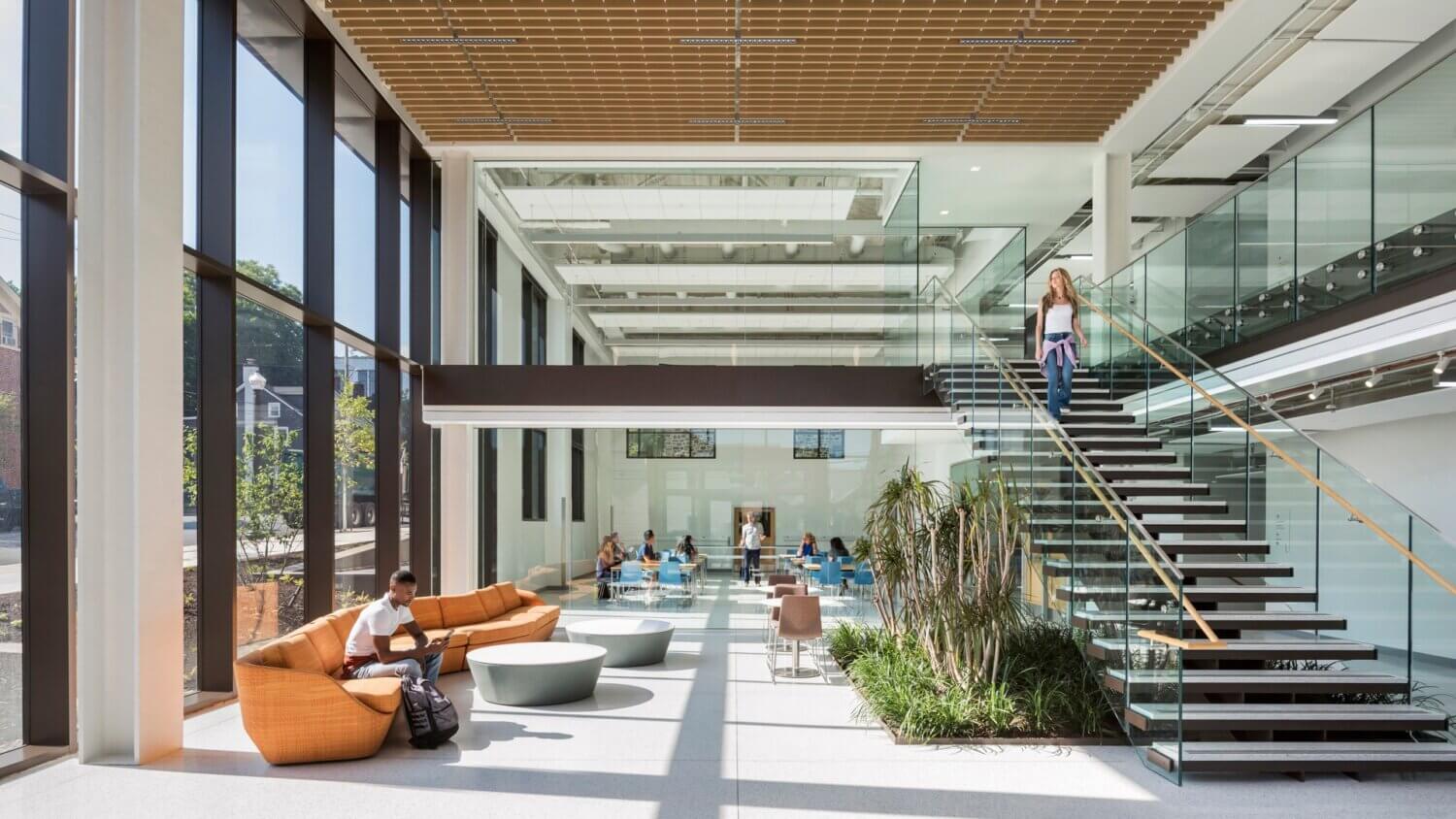 Students going down stairs at lehigh in room with large windows