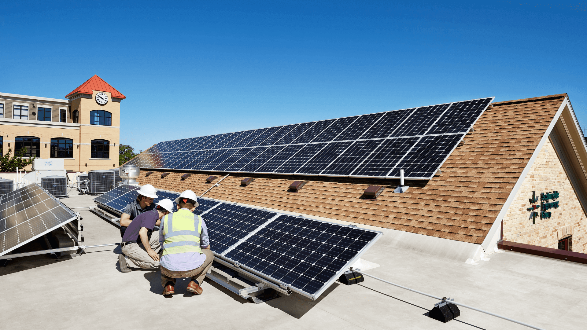 Men on roof of HGA Madison working on solar panels