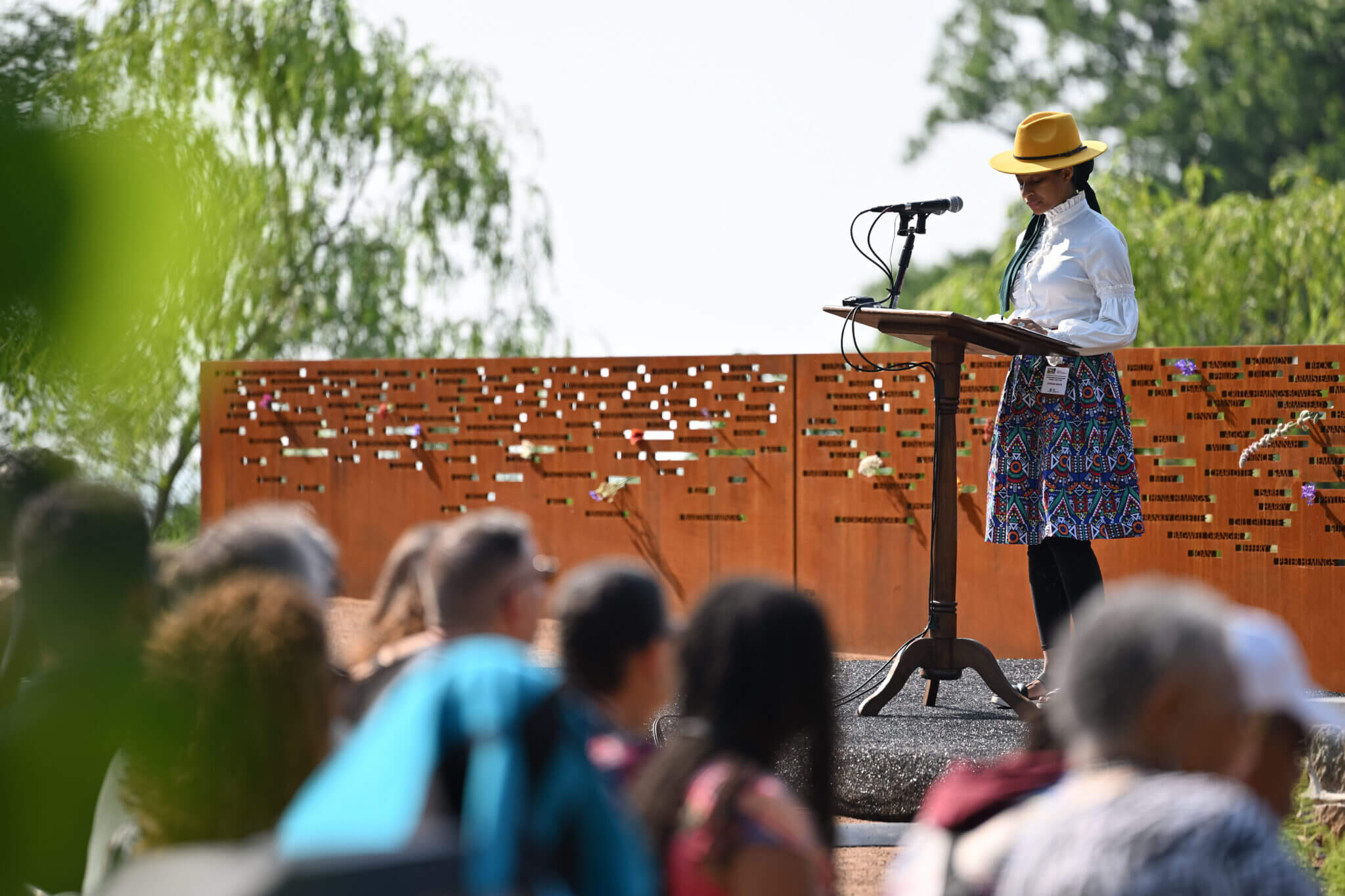 Speaker reading at an event at the Thomas Jefferson Foundation – Monticello Contemplative Site and Burial Ground for Enslaved People in Charlottesville, VA
