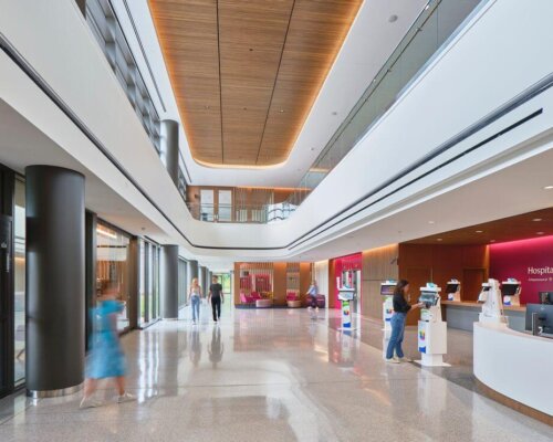 Interior of a healthcare building lobby with high wood ceilings and bright natural light