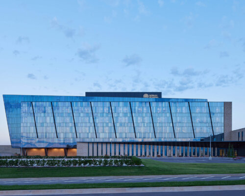 Large modern glass building at dusk
