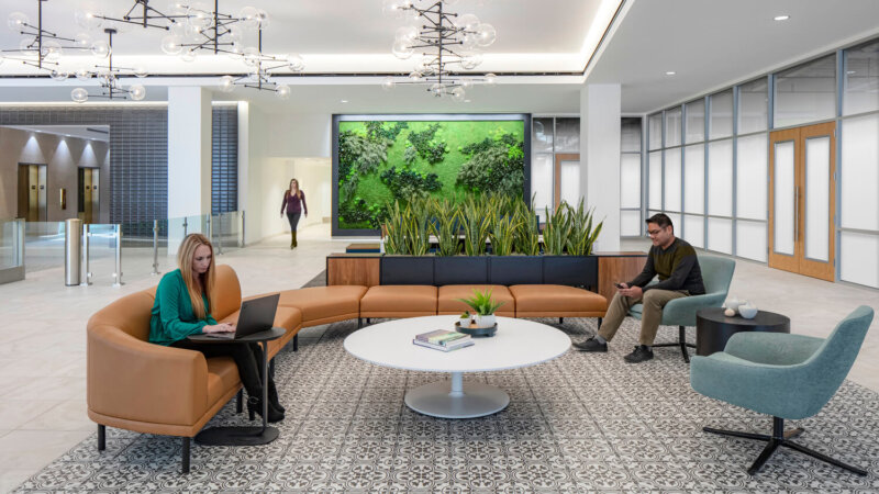 Team mates working on lobby with greenery background