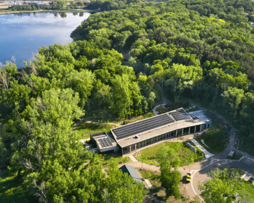Aerial View of Westwood Hills Nature Center surrounded by trees and a lake